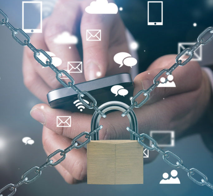 An image of a lock and chain with cyber icons & a person using their smartphone - Manning Insurance Services.