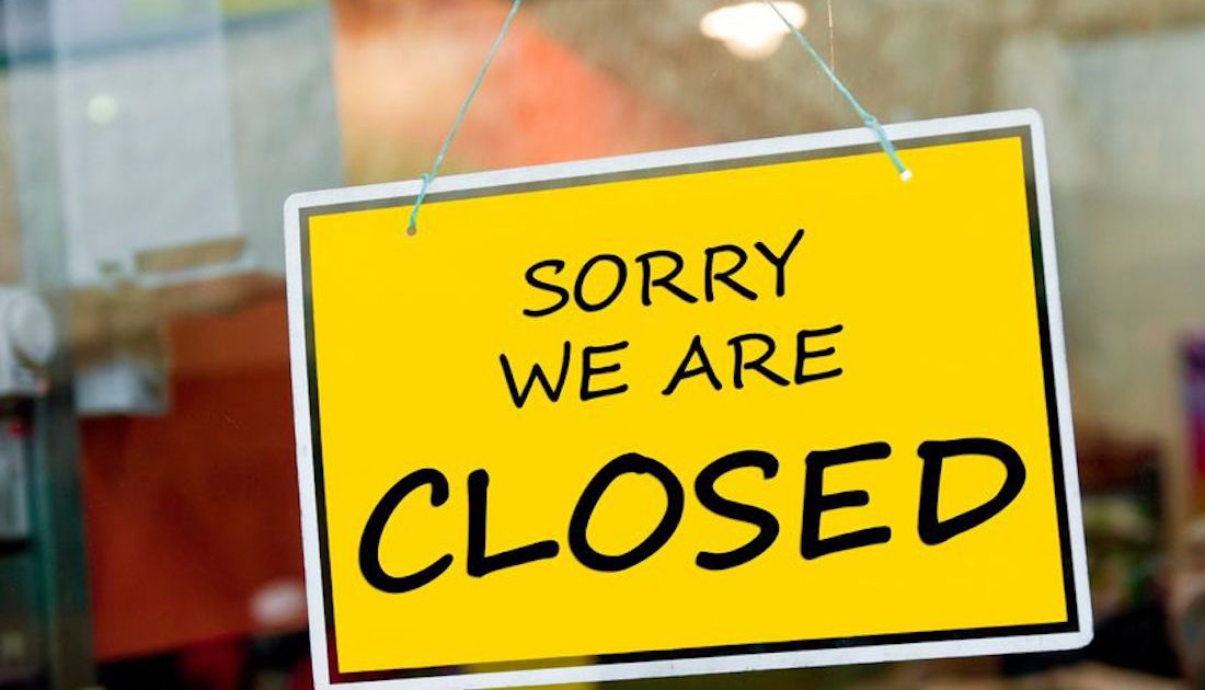 A sign on the window, noting Sorry We are Closed - Manning Insurance Services.