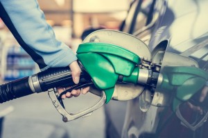 38741672 - pumping gas at gas station. close up of a hand holding fuel nozzle.