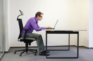 20067343 - bad sitting posture at laptop . man on chair